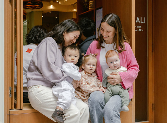 Matchali founders sitting with their children